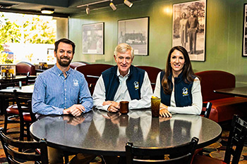 Hamp Lindsey &##x28;center&##x29; took over operations of Wade&rsquo;s Restaurant as a recent college graduate in 1977. He has turned over daily operations and future projects like Wade&rsquo;s Jr. to his children, Anna &##x28;right&##x29; and Wade III &##x28;left&##x29;, and the company&rsquo;s chief operating officer Joey Basso. In addition to being grateful for the family legacy to continue, he&rsquo;s looking forward to more flying time in his single-engine Cessna and playing more golf.